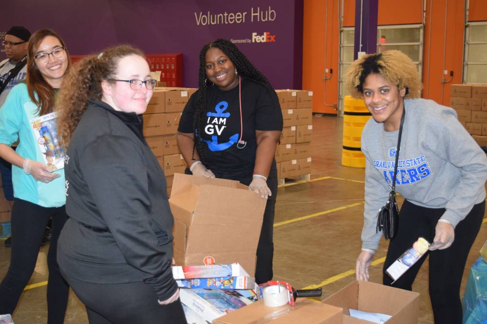 Photo of students packing boxes at food bank